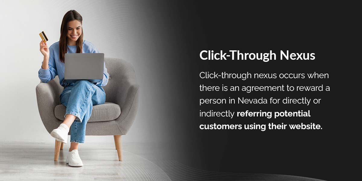 a woman is sitting in a chair using a laptop and holding a credit card