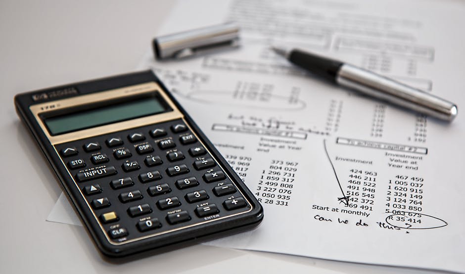 Calculator and pen on top of tax document