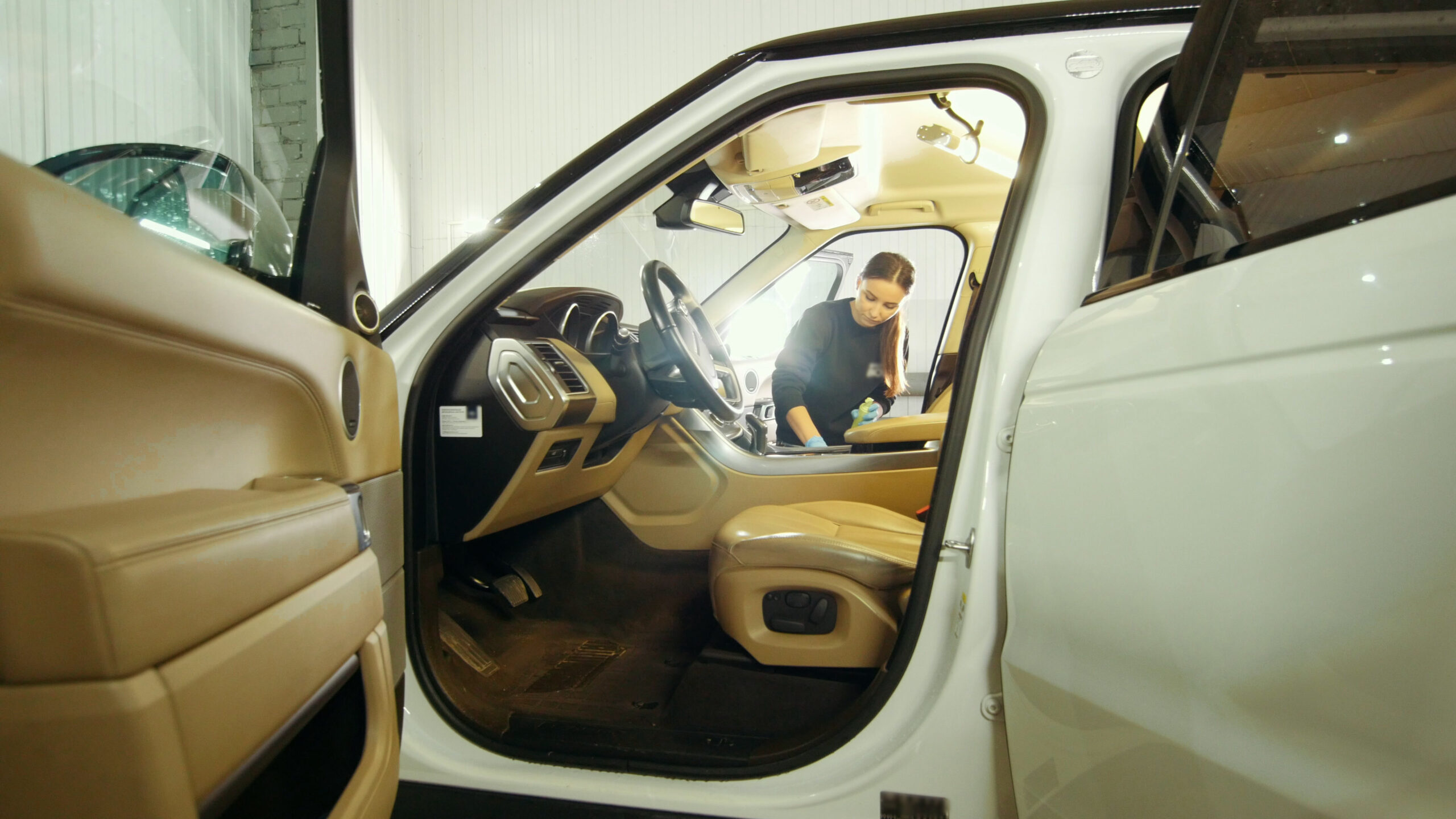 woman-in-blue-gloves-is-cleaning-interior-of-the-car-for-luxury-suv-SBI-351081397-scaled