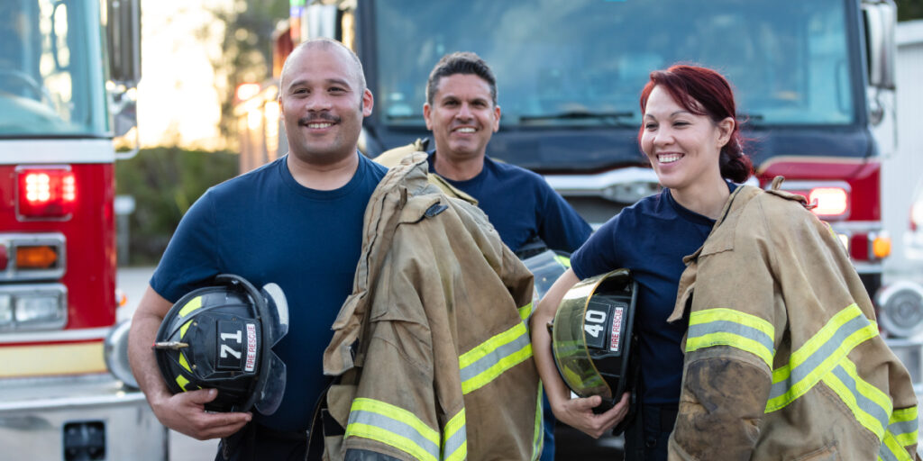 a group of fire fighters carrying their gear